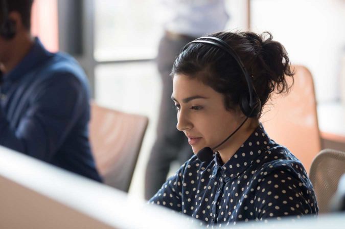a woman working with a headset on