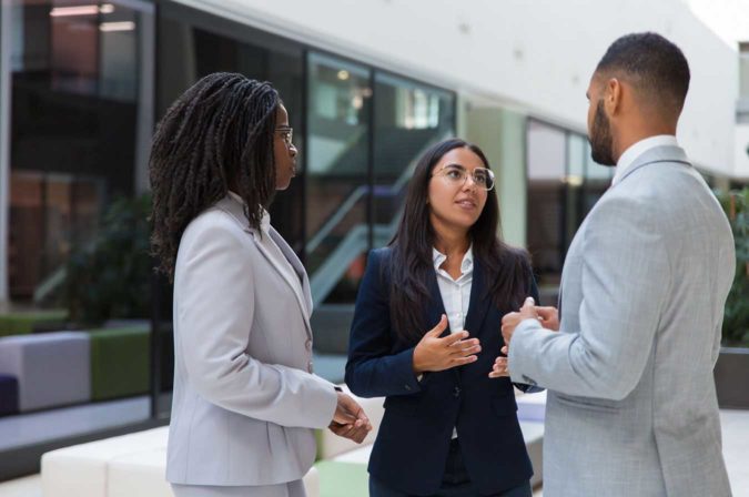 Diverse group of young professionals having a discussion outside